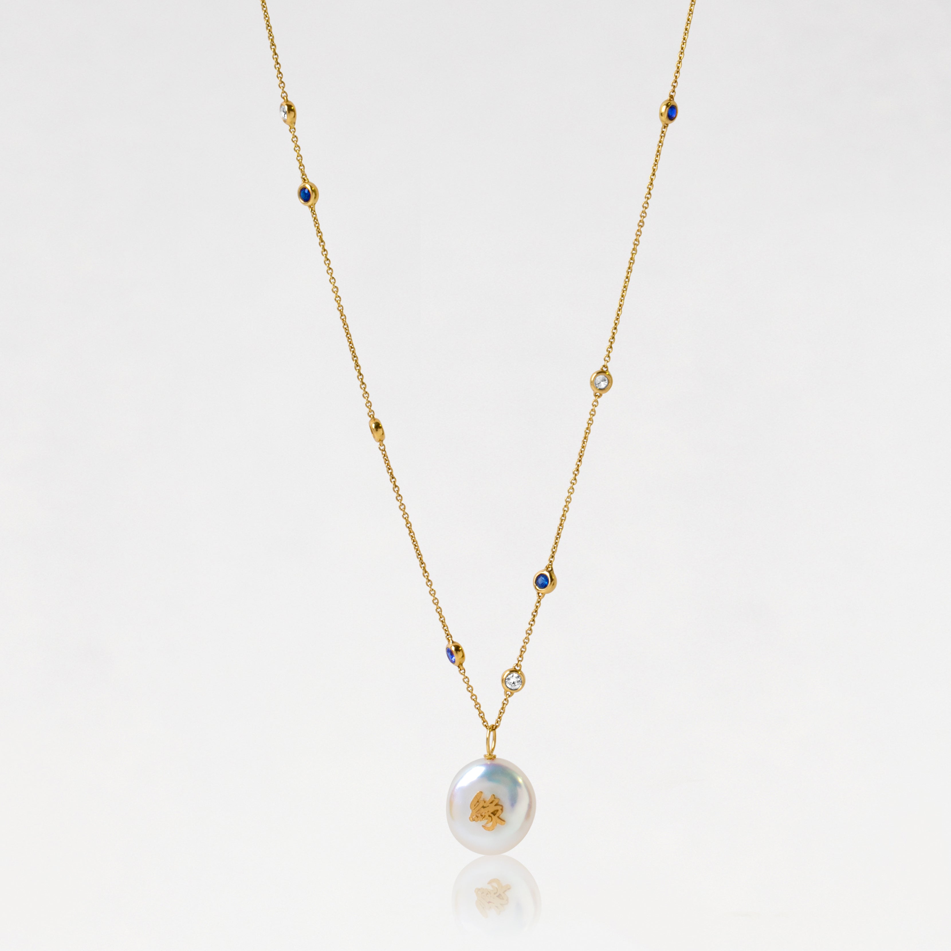 18k yellow gold Sere ndipity 緣Chinese character pendant with a white freshwater pearl on a delicate gold chain